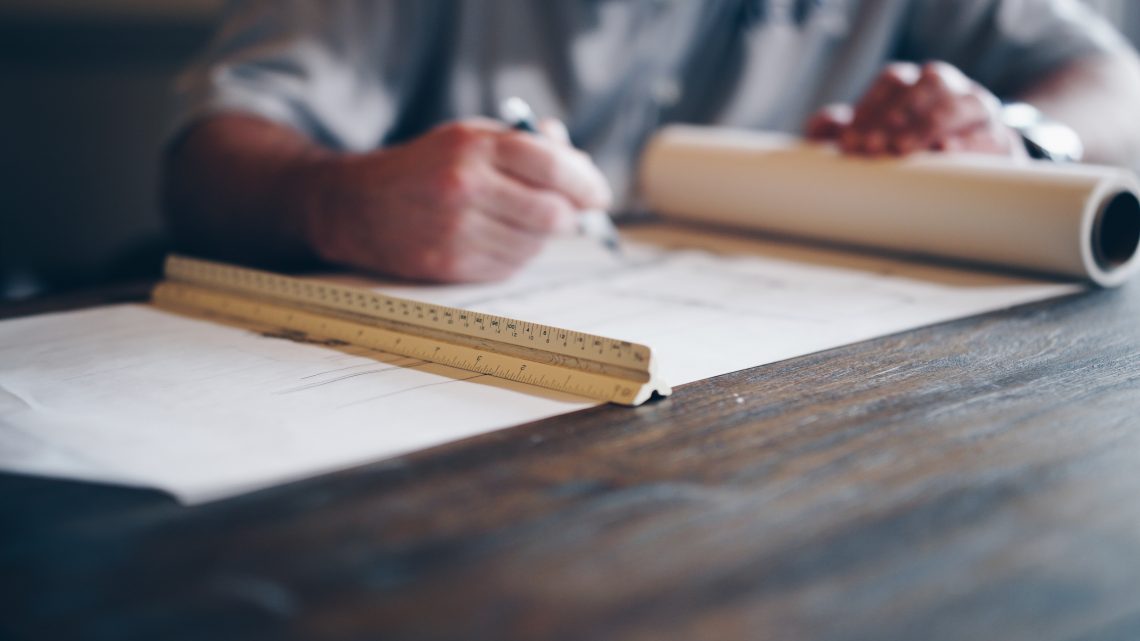 Architect Technician drafting building papers.